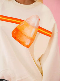 Spooky Halloween Sequin Sweatshirt showing the reversible design from black with orange sequins to orange with black sequins.