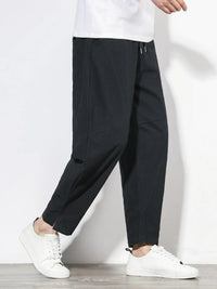 Plus size men's relaxed fit pants showing multiple pockets and style