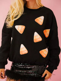 Spooky Halloween Sequin Sweatshirt showing the reversible design from black with orange sequins to orange with black sequins.
