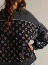 Women's Dropped Shoulder Hoodie in black, showing the front pocket and oversized fit on a model.