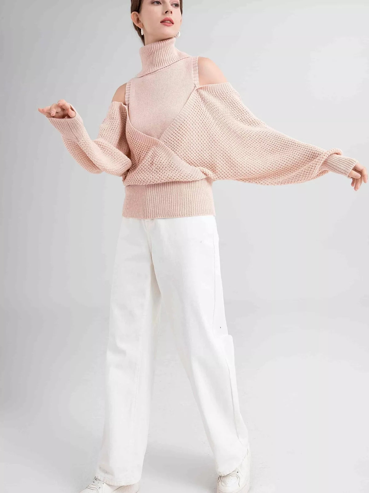 Oversized Cold Shoulder Sweater in Cream knit worn with denim jeans