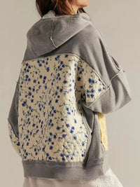 Women's Dropped Shoulder Hoodie in gray, showing the front pocket and oversized fit on a model.