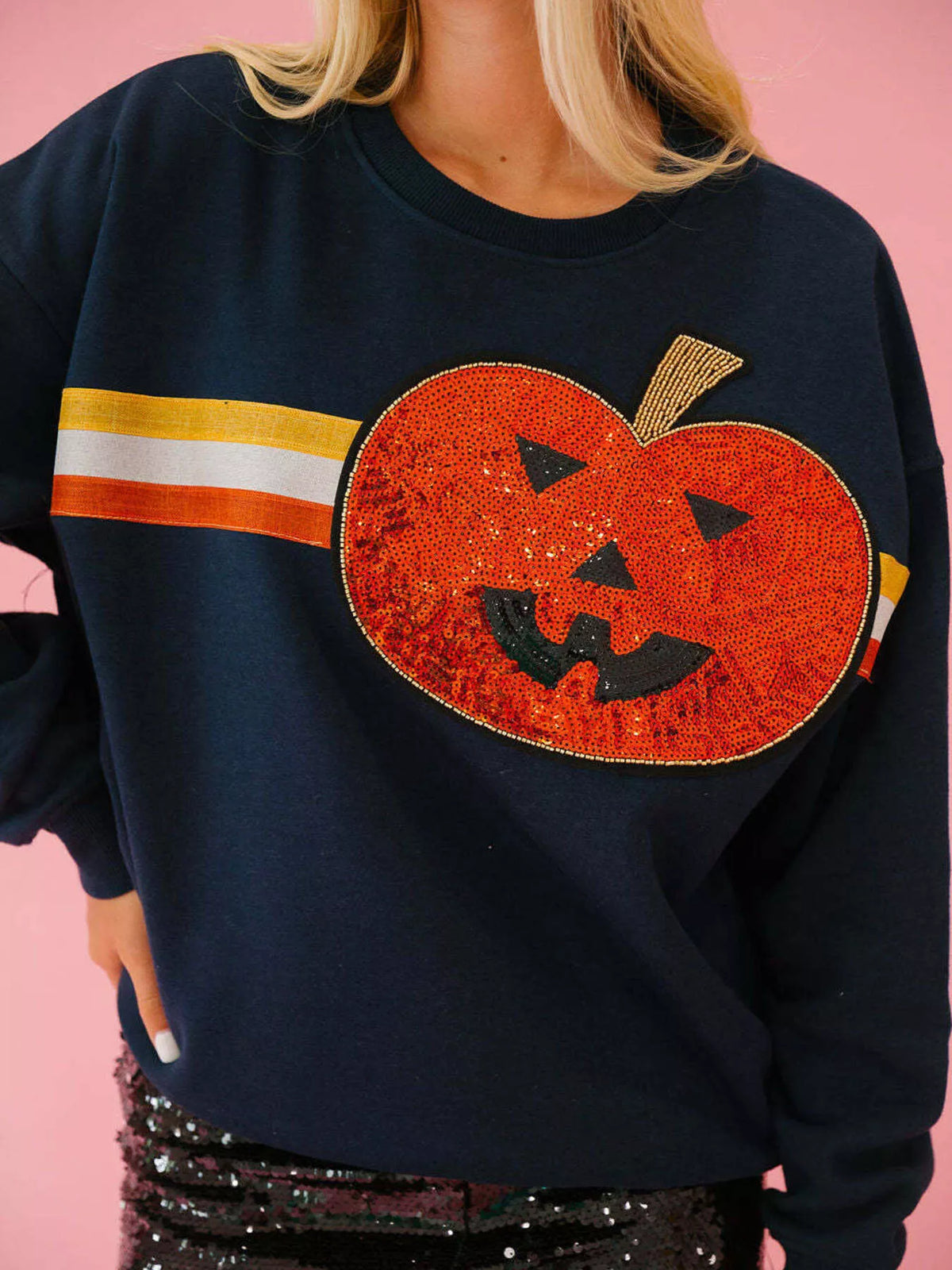 Spooky Halloween Sequin Sweatshirt showing the reversible design from black with orange sequins to orange with black sequins.
