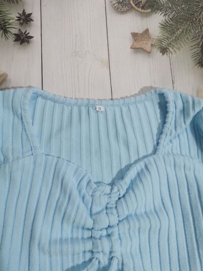 Women’s ruched drawstring ribbed long sleeve top in beige, styled with jeans for casual fall outfit