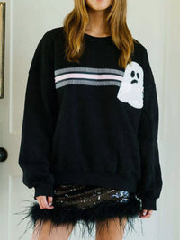 Spooky Halloween Sequin Sweatshirt showing the reversible design from black with orange sequins to orange with black sequins.