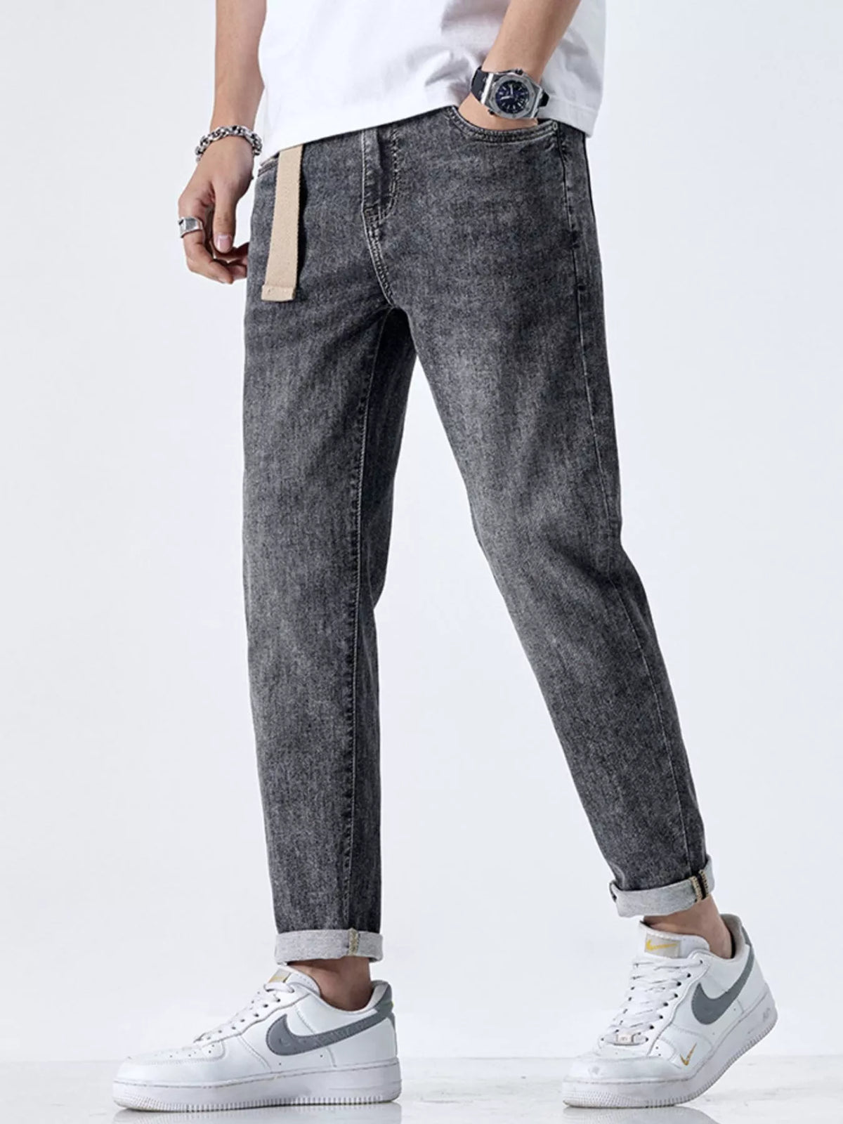 Side profile of relaxed fit men's black jeans with cat's whisker detail