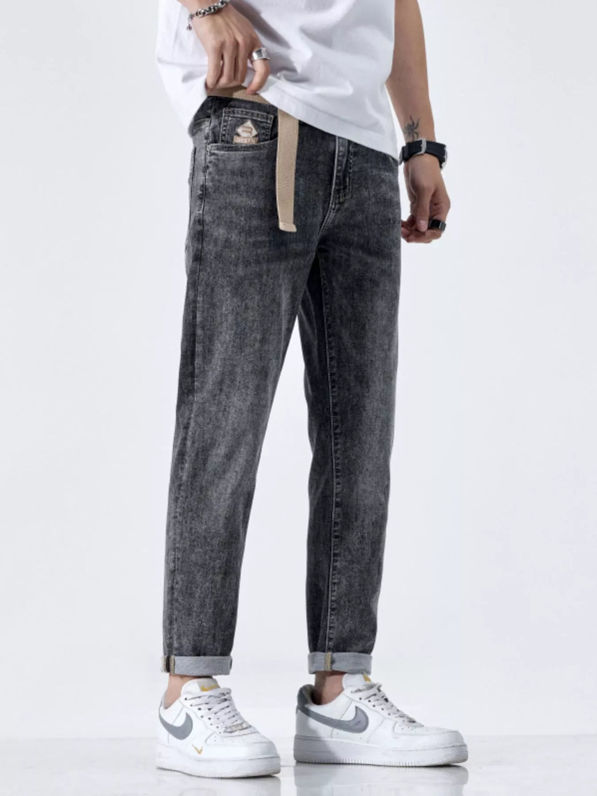 Side profile of relaxed fit men's black jeans with cat's whisker detail