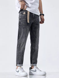 Side profile of relaxed fit men's black jeans with cat's whisker detail