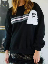 Spooky Halloween Sequin Sweatshirt showing the reversible design from black with orange sequins to orange with black sequins.