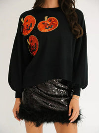 Spooky Pumpkin Sequin Sweatshirt reversible from pumpkin to moon and bats design on a model