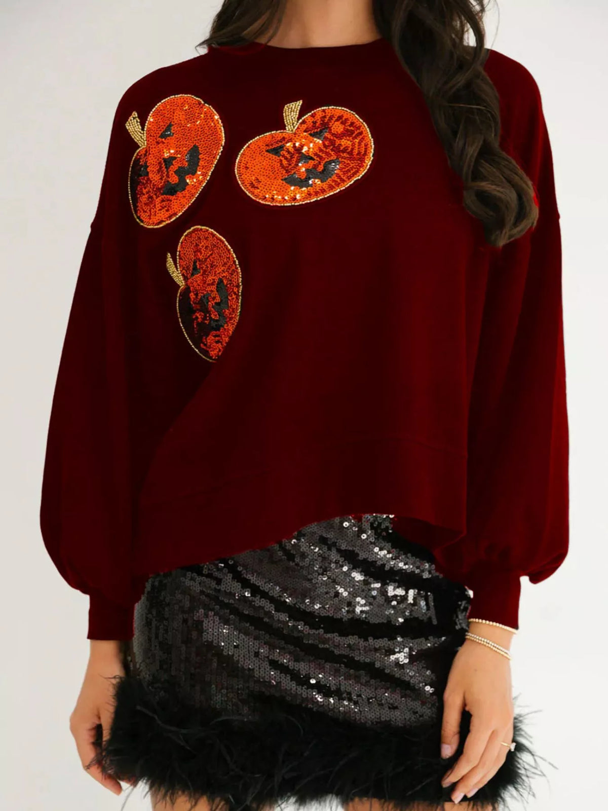 Spooky Pumpkin Sequin Sweatshirt reversible from pumpkin to moon and bats design on a model