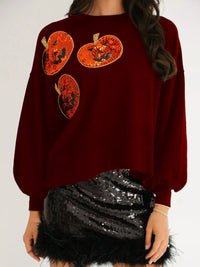 Spooky Pumpkin Sequin Sweatshirt reversible from pumpkin to moon and bats design on a model