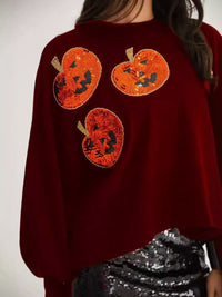 Spooky Pumpkin Sequin Sweatshirt reversible from pumpkin to moon and bats design on a model