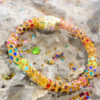 Rainbow Crystal Bracelet showcasing dainty gold chain with multicolored crystals.