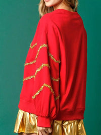 Sparkle Christmas Tree Sweatshirt on a model against a festive background.