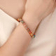 Rainbow Crystal Bracelet showcasing dainty gold chain with multicolored crystals.