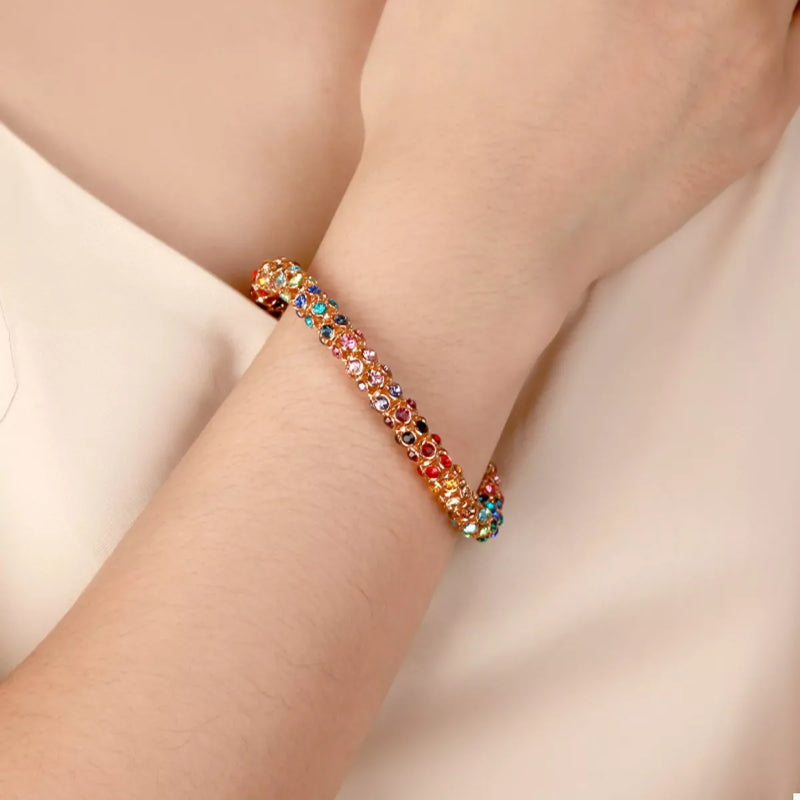 Rainbow Crystal Bracelet showcasing dainty gold chain with multicolored crystals.