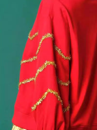 Sparkle Christmas Tree Sweatshirt on a model against a festive background.