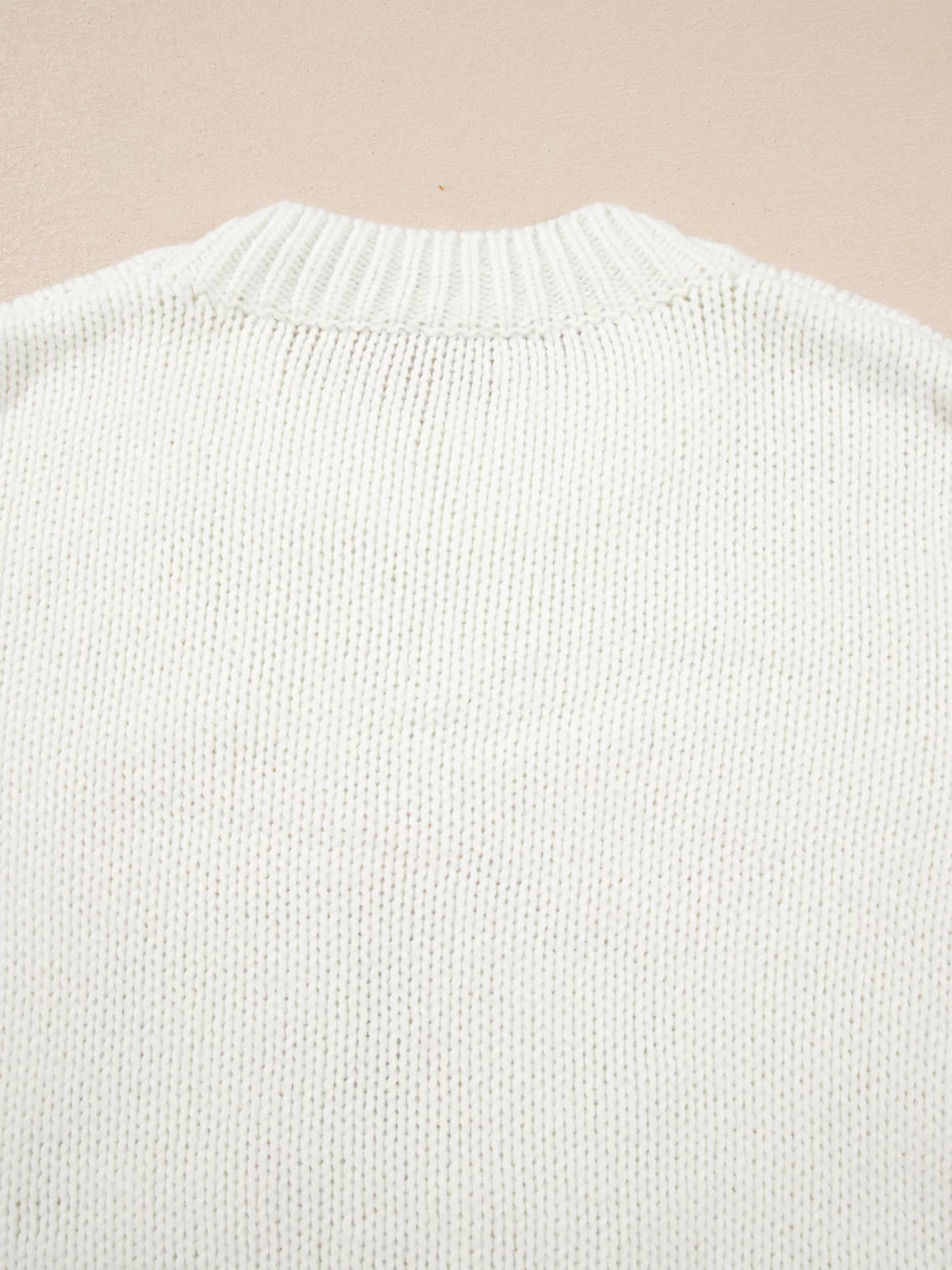 Women's Embroidered Bow Boots Drop Shoulder Sweater in cream, laid flat showing the detailed boot and bow design on the front.