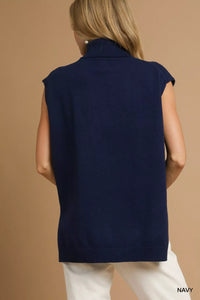 Women's Ribbed Sleeveless Turtleneck Top worn by a woman with Navy layering.
