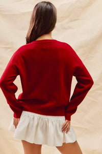 Cozy Teddy Bear Christmas Sweater with red check ribbon and festive holiday design on a soft women's pullover.