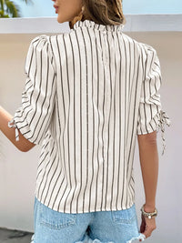 Women's Striped Half Sleeve Blouse laid flat on a table with accessories