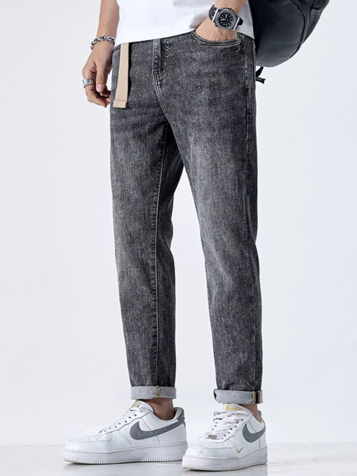 Side profile of relaxed fit men's black jeans with cat's whisker detail