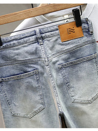 Men's distressed wide leg jeans in washed blue denim with knee rips, 90s grunge style