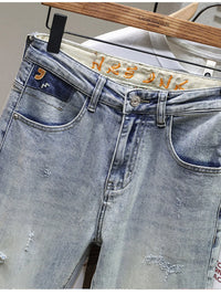 Men's distressed wide leg jeans in washed blue denim with knee rips, 90s grunge style