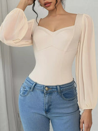 Women's sweetheart neck balloon sleeve bodysuit outfit, Apricot, styled with jeans.
