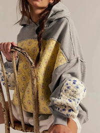 Women's Dropped Shoulder Hoodie in gray, showing the front pocket and oversized fit on a model.