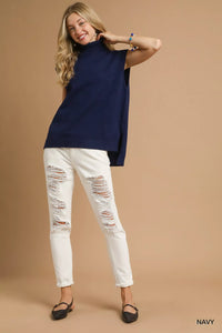 Women's Ribbed Sleeveless Turtleneck Top worn by a woman with Navy layering.