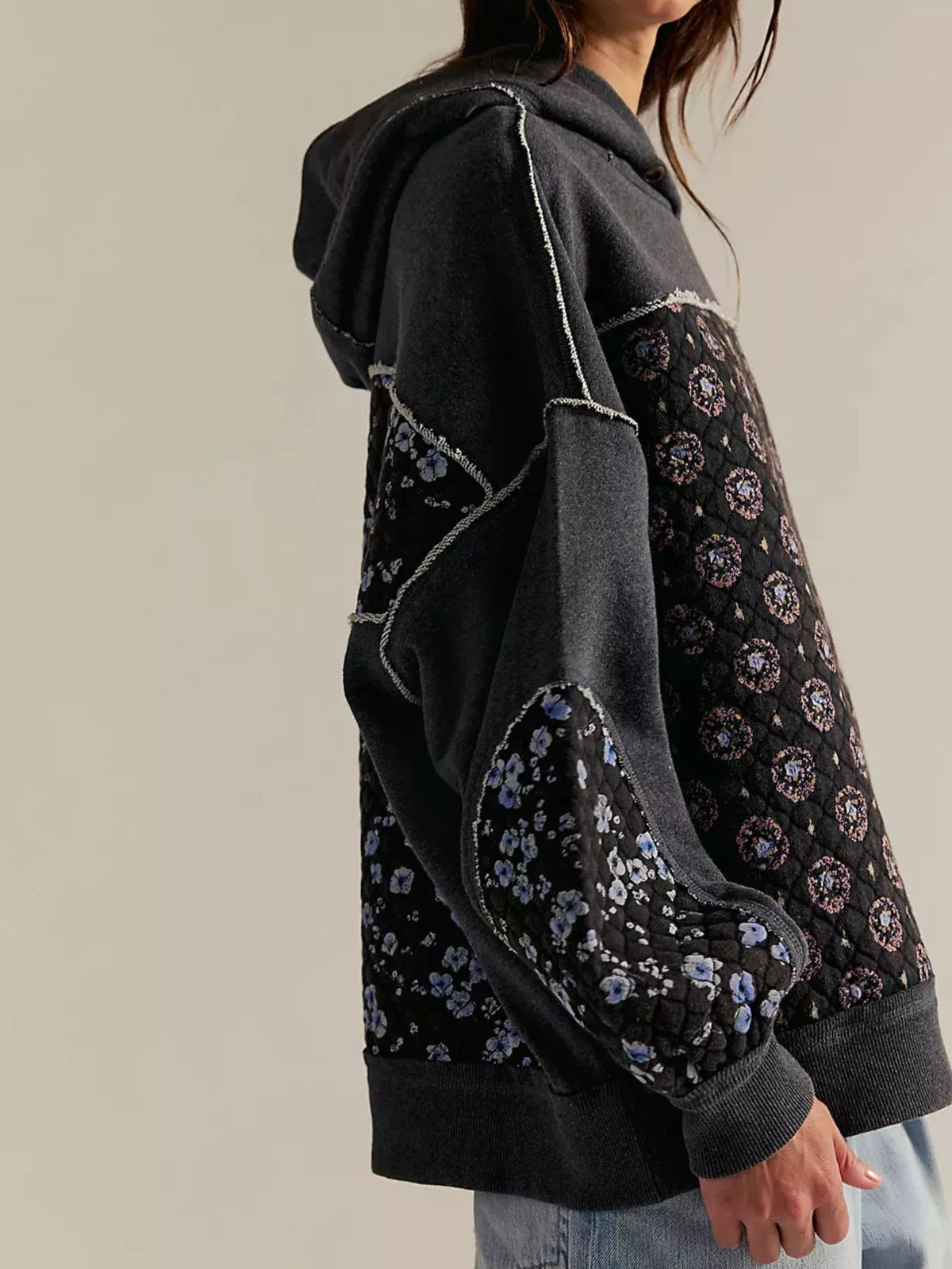 Women's Dropped Shoulder Hoodie in black, showing the front pocket and oversized fit on a model.