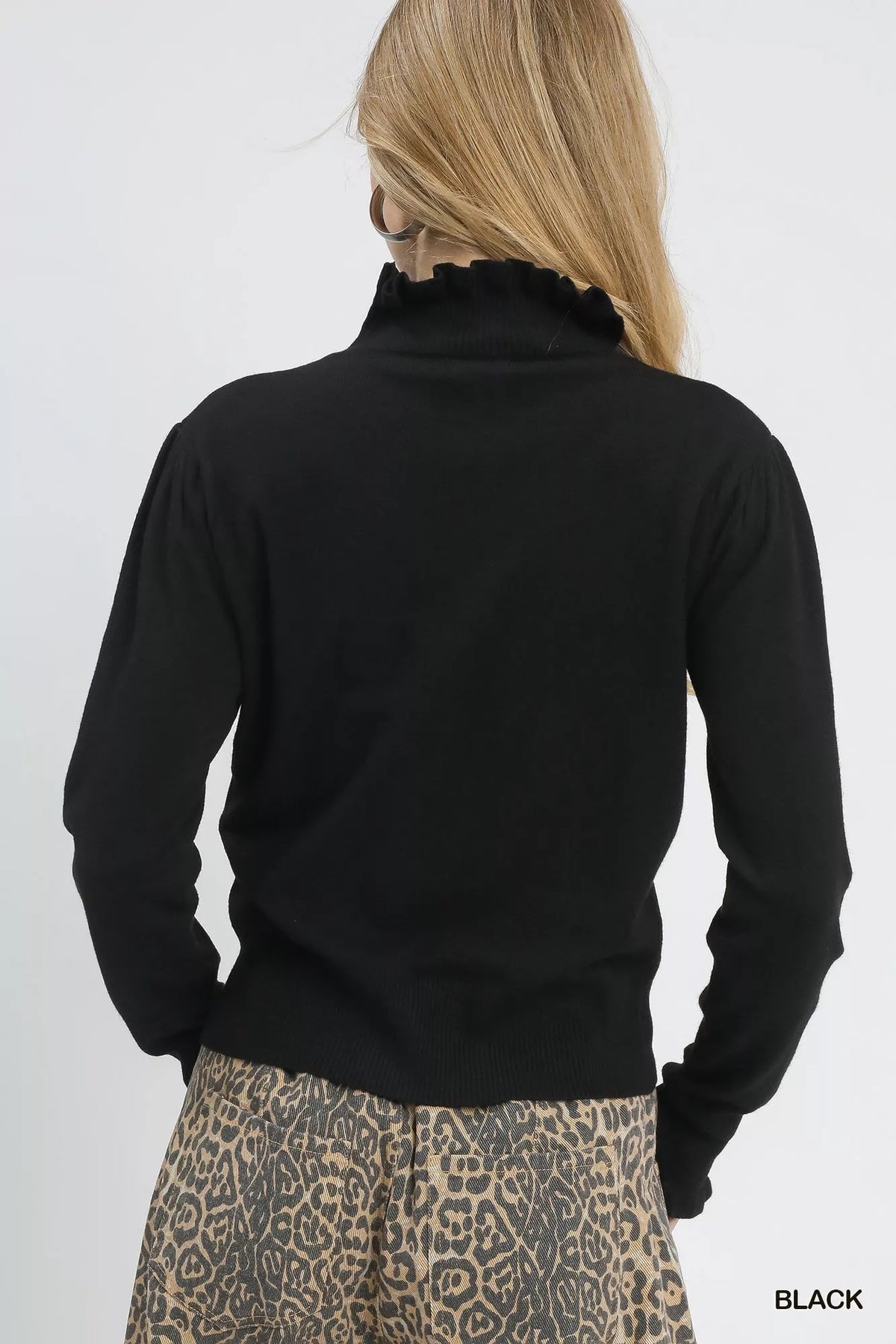 Puff Sleeve Sweater with Ruffle Detail and Mock Neck shown in Black on a model.