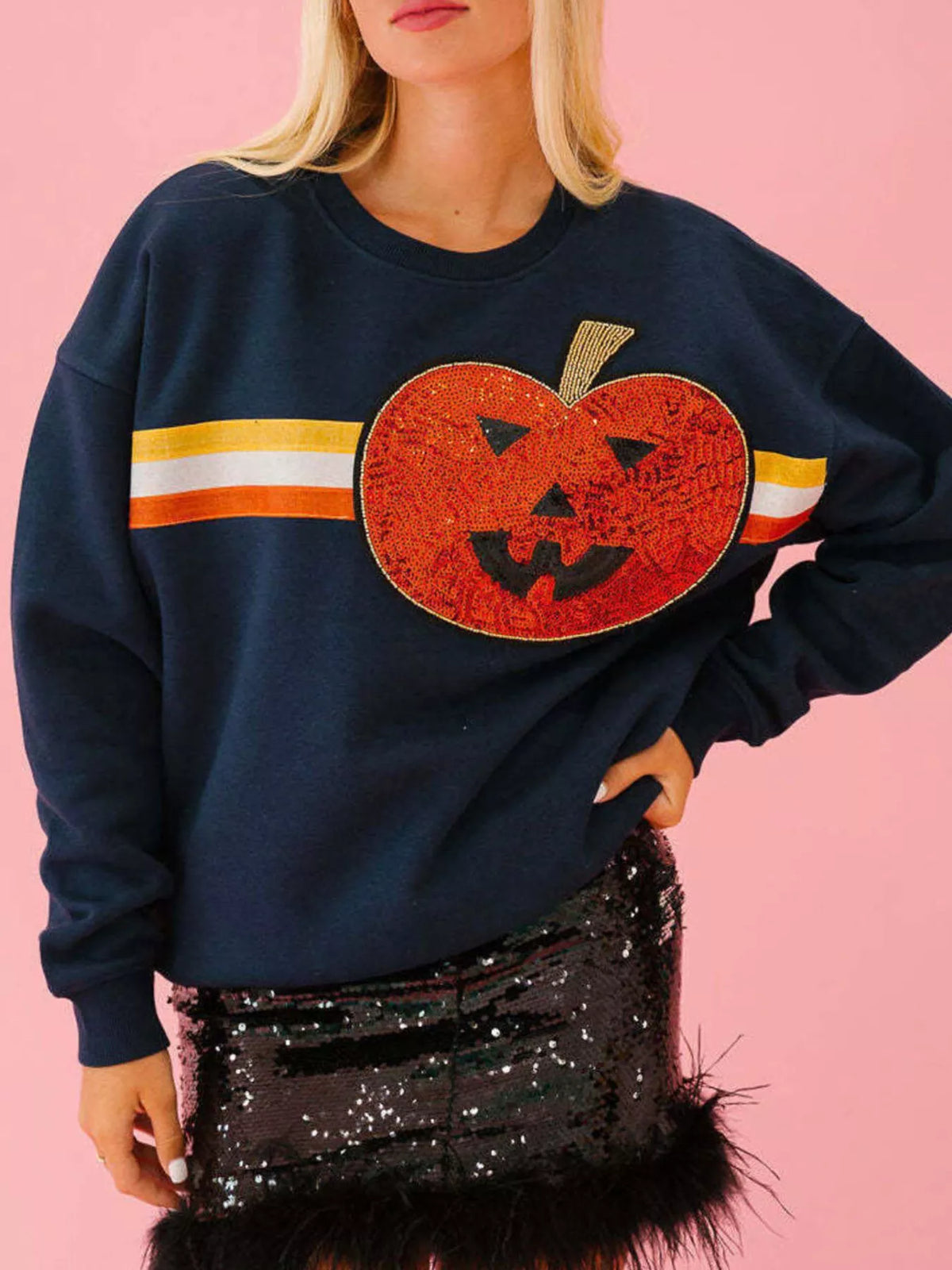 Spooky Halloween Sequin Sweatshirt showing the reversible design from black with orange sequins to orange with black sequins.