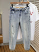 Men's distressed wide leg jeans in washed blue denim with knee rips, 90s grunge style
