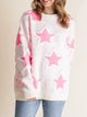 Oversized Star Pattern Sweater in White worn with boots