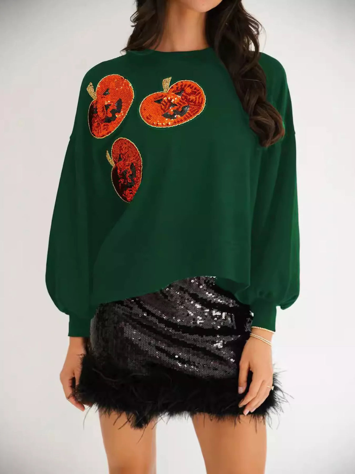 Spooky Pumpkin Sequin Sweatshirt reversible from pumpkin to moon and bats design on a model