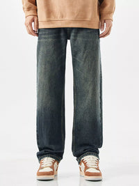 Men's relaxed fit wide leg jeans in vintage blue wash, front view.