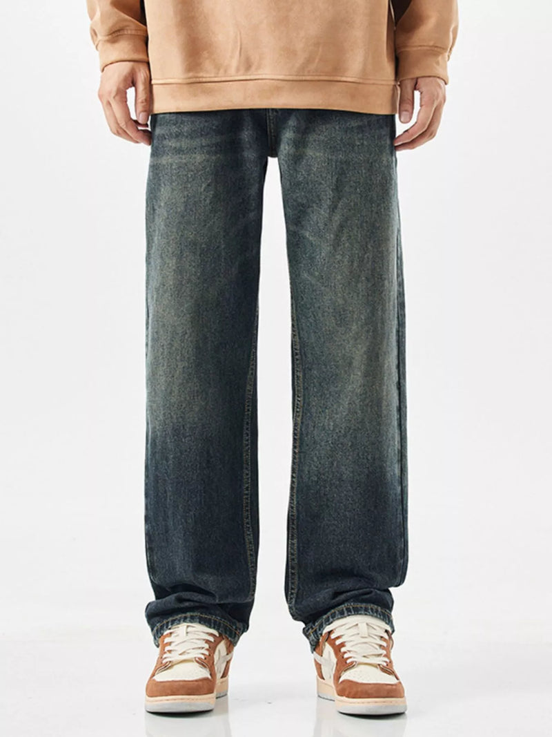 Men's relaxed fit wide leg jeans in vintage blue wash, front view.