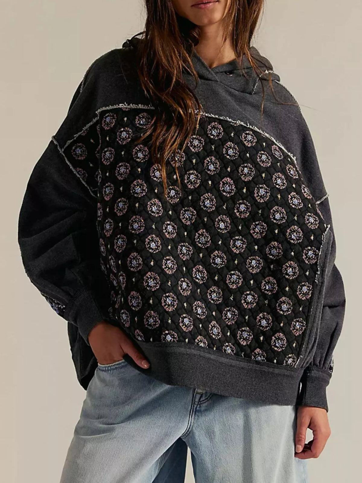 Women's Dropped Shoulder Hoodie in black, showing the front pocket and oversized fit on a model.