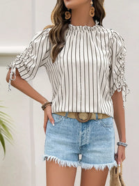 Women's Striped Half Sleeve Blouse laid flat on a table with accessories