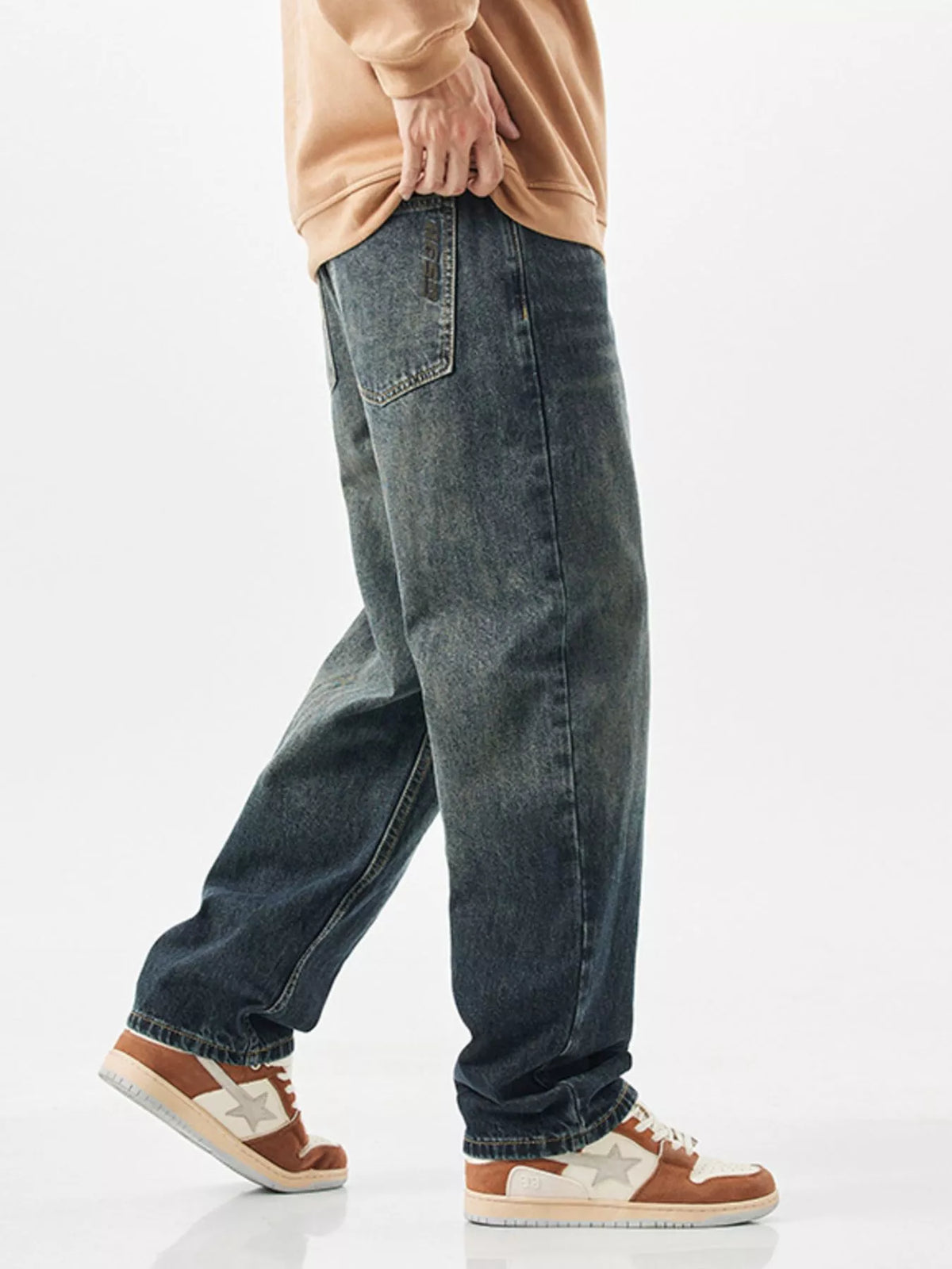 Side profile of men's 90s style wide leg denim pants showcasing the fit.