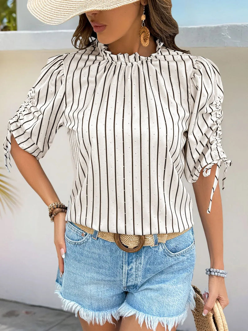 Women's Striped Half Sleeve Blouse laid flat on a table with accessories