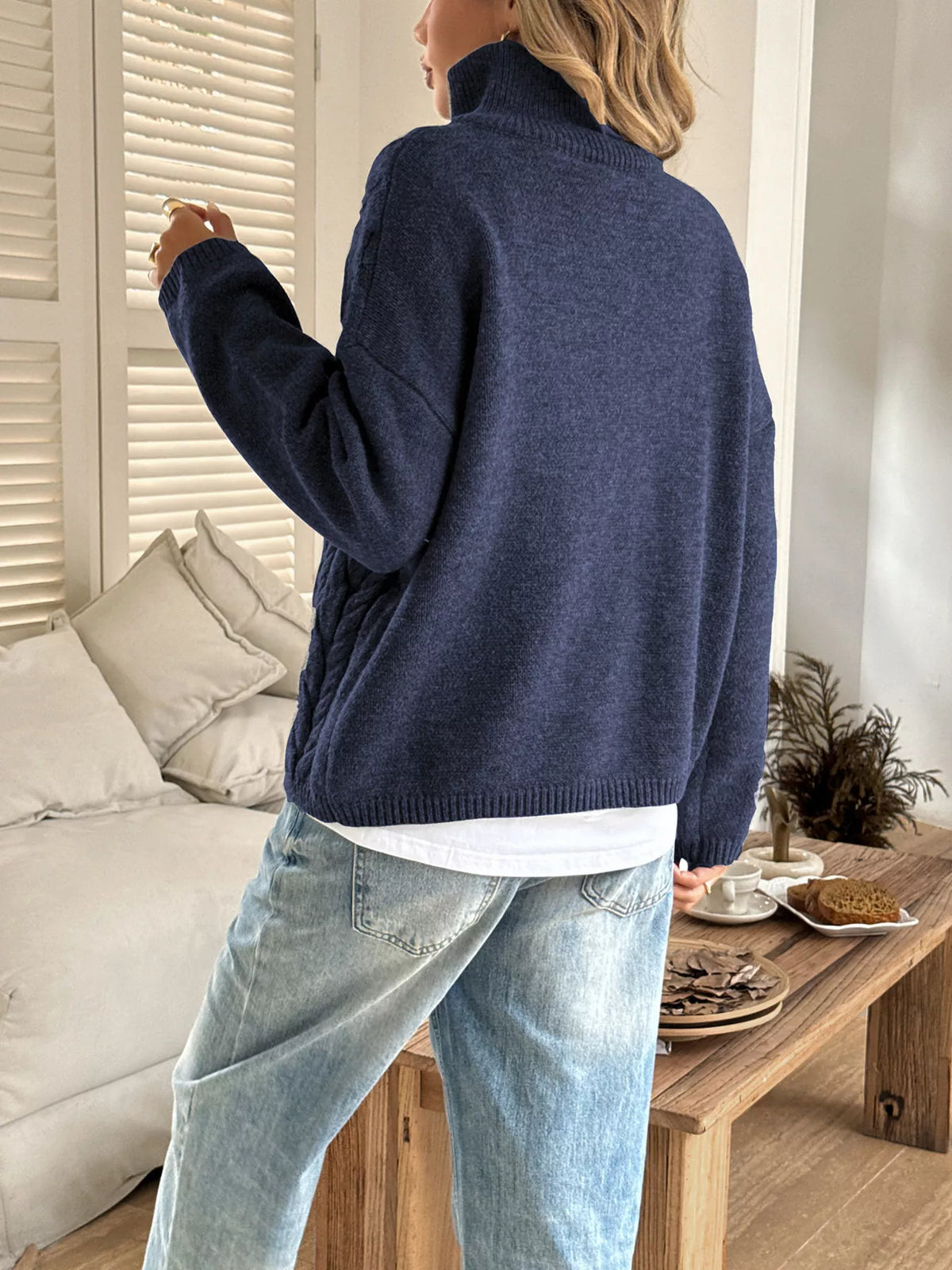 Women's Cable Knit Zip Neck Sweater in Navy worn with boots