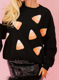 Spooky Halloween Sequin Sweatshirt showing the reversible design from black with orange sequins to orange with black sequins.
