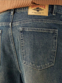 Men's Washed Wide Leg Jeans - Front view showing relaxed fit and light blue wash on a model.