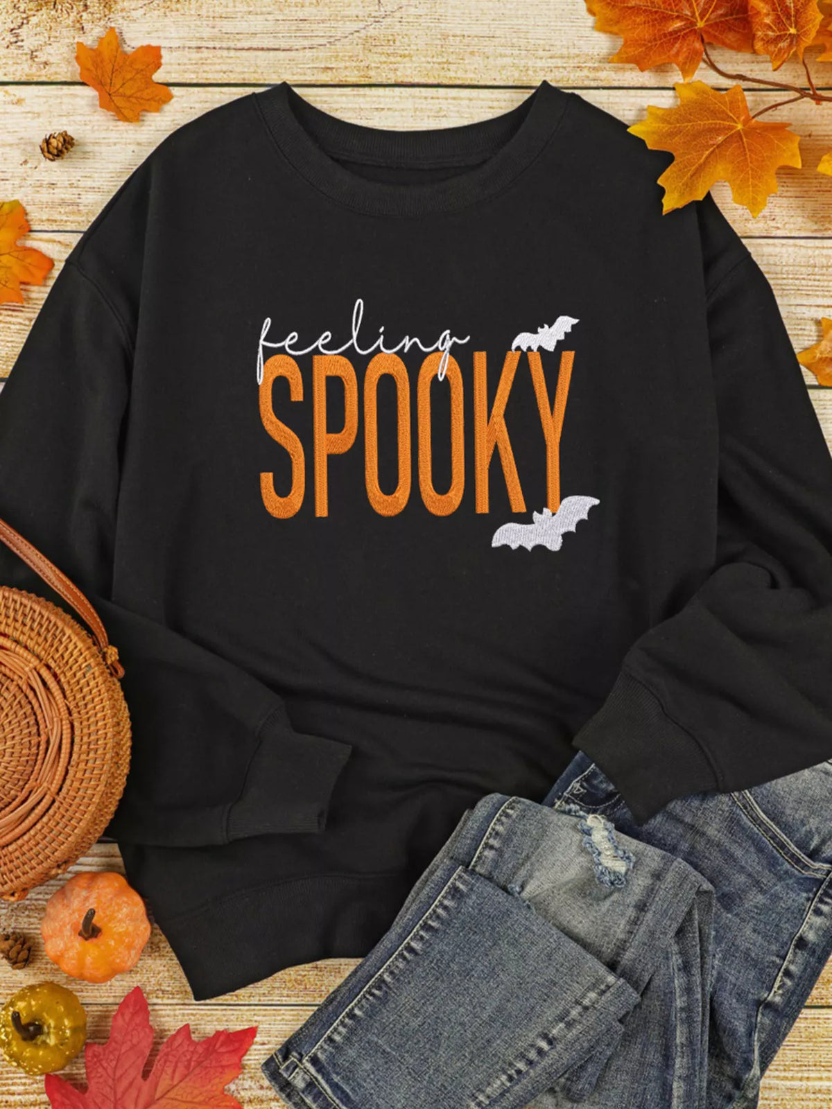 Feeling Spooky Halloween embroidered sweatshirt for women, black crewneck fall fashion.