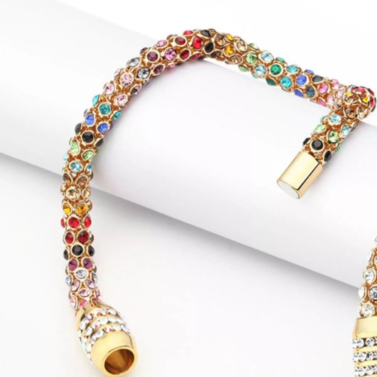 Rainbow Crystal Bracelet showcasing dainty gold chain with multicolored crystals.