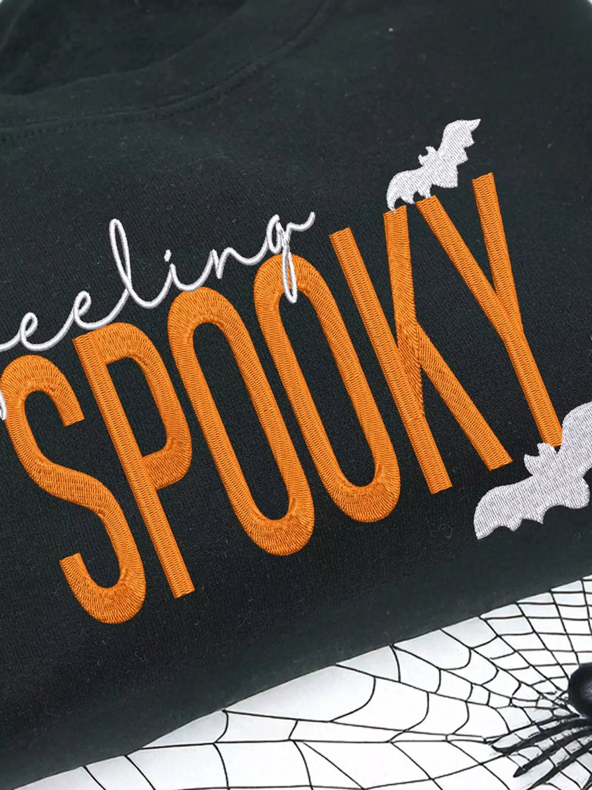 Feeling Spooky Halloween embroidered sweatshirt for women, black crewneck fall fashion.